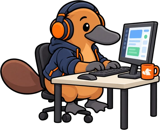 Platy at a desk in headphones and a hoodie, typing at a computer.